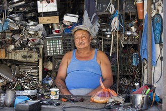 Kyrgyz repairman in little workshop in the city Osh
