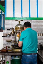Preparing coffee on a historic espresso machine
