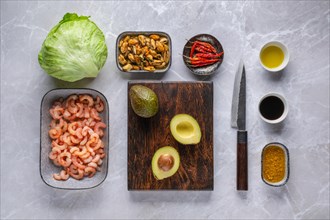 Overhead view of ingredients for shrimp salad with mussel and avocado