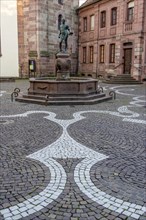 Schuster-Joss fountain in the main street with pavement mosaic in the pedestrian zone