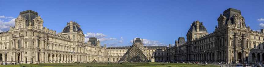 Panoramic photo of the Louvre Museum building and the glass pyramid