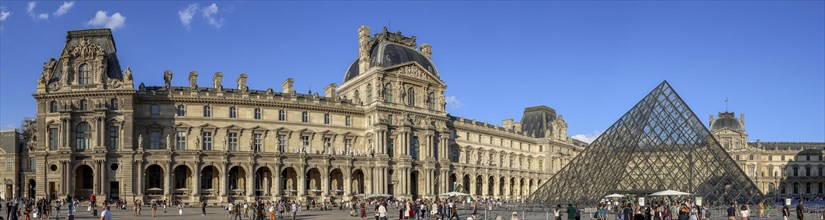 Panoramic photo of the Louvre Museum building and the glass pyramid