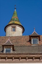 The roof of the building in Obere Strasse with a small coloured tower and two skylights in the old town