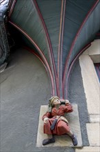 Sculpture of a little man in red clothes