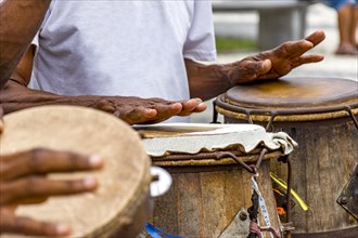 Percussionists playing their instruments during a capoeira performance in a Pelourinho square in the city of Salvador