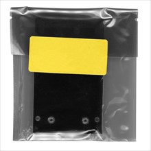 Sachet with yellow tag label isolated over white