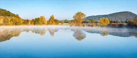 Lake with morning mist in autumn