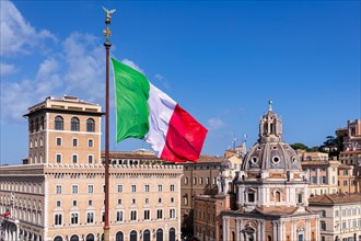 The Italian flag seen in front of the Church of Santa Maria di Loreto al Foro Traiano on the right