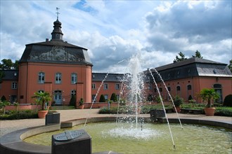 Castle in the park with a fountain in front