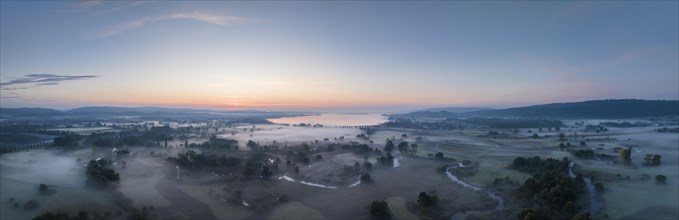 Aerial panorama of the Radolfzeller Aachried in front of sunrise and ground fog