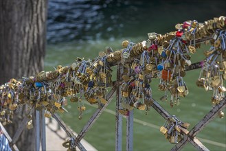 Love locks on a railing on the banks of the Seine