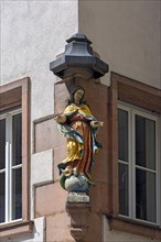 Statue of the Virgin Mary as a house saint on a residential building