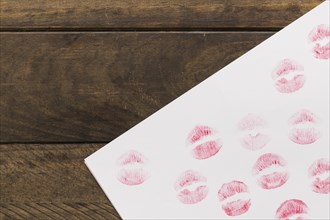 Lipstick kisses paper wooden board