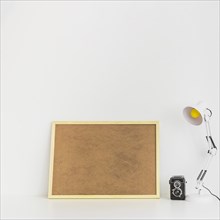 Minimalistic workspace with cork board old camera