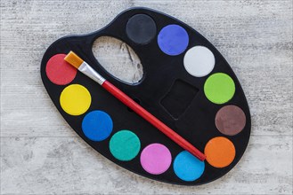 Multicolored artist tray palette wooden background