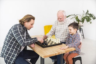 Multigenerational men playing chess