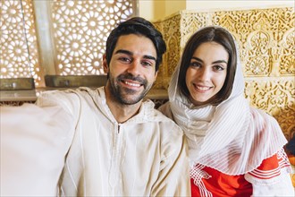 Muslim couple taking selfie restaurant