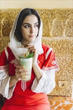 Muslim woman with delicious drink
