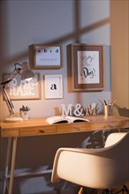 Neat organised workspace with chair lamp