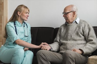 Nurse holding old man s hand nursing home