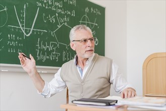 Old teacher explaining lecture room