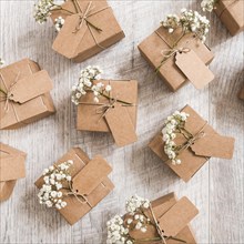 Overhead view wedding gift boxes with baby s breath flowers wooden desk