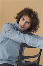 Portrait curly haired young man 14