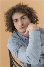 Portrait curly haired young man 15