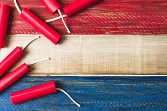 Red dynamite firecrackers wooden painted wooden plank background