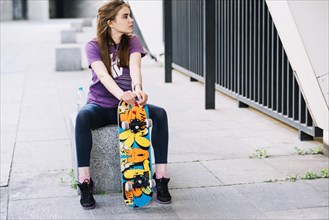 Skateboarder girl looking left