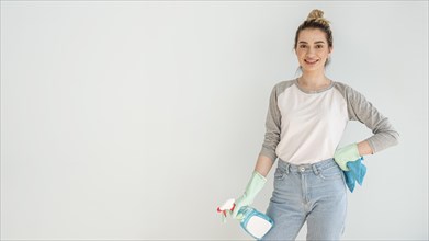 Smiley woman posing while holding cleaning solution cloth