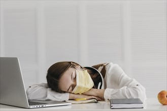 Student wearing medical mask sleeping