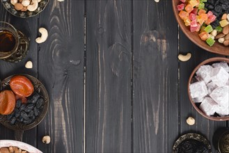 Turkish tea dried fruits raisins nuts lukum black textured wooden desk