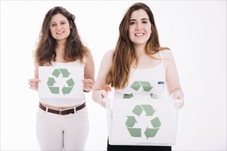 Two woman holding recycle placard crate against white background