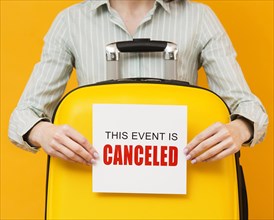 Woman holding cancelled event card