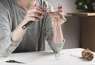 Woman knitting with needle home