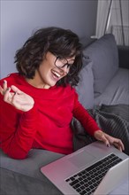 Woman red using laptop