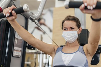 Woman working out gym during pandemic