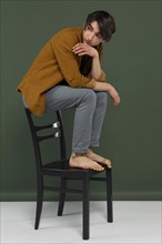 Young man wearing shirt posing chair 4