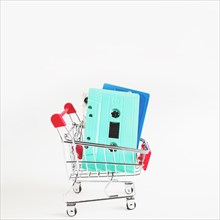 Blue turquoise cassette tapes shopping cart isolated white background