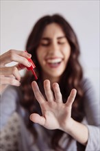 Blurred woman painting nails
