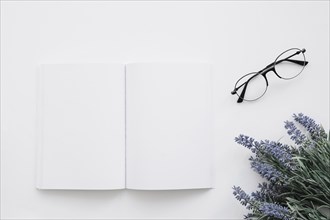 Book cover mockup with glasses flower decoration