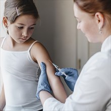 Child doctor getting vaccine