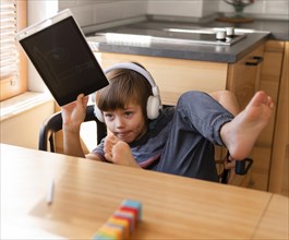Child holding drawing online school interactions