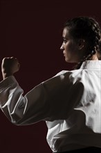 Close up sideways woman white karate uniform