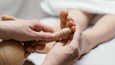 Close up therapist using wooden tool