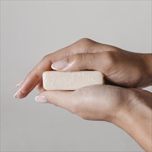 Close up woman holding block soap