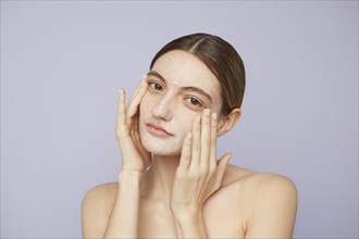 Close up woman using facial mask