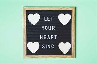 Decorated board with message heart shape turquoise backdrop