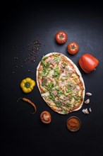 Delicious pizza with ingredients spices wallpaper